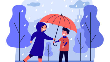 Happy woman in raincoat giving umbrella to boy.