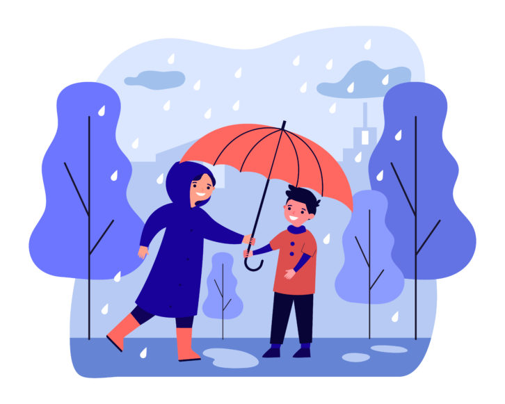 Happy woman in raincoat giving umbrella to boy. 
