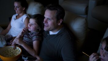 Family watching a movie in a home theater