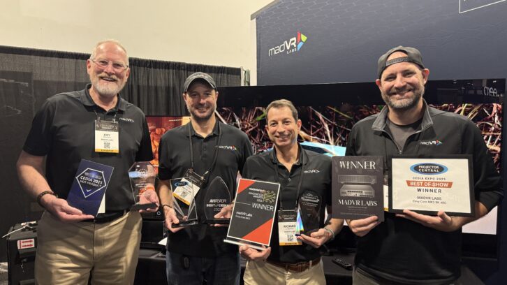 A shot highlighting some of madVR’s 13 awards from CEDIA Expo 2025, along with key members of the team: (from left to right) Joey Peacock, global sales manager; Jason Dustal, senior field specialist; Richard Litofsky, co-founder and CEO; and Ryan Charpentier, head of support and training.