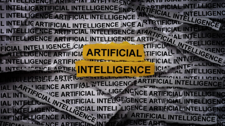 Strips of newspaper with the words Artificial Intelligence typed on them. Close up.