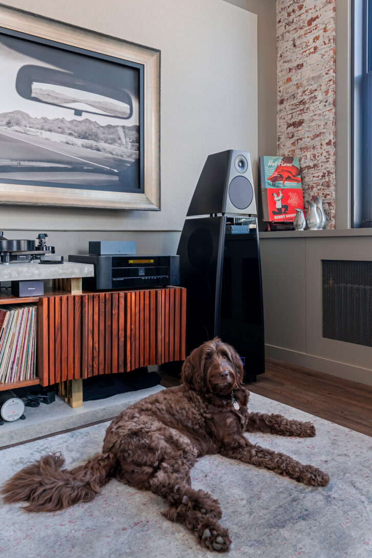 A 2-channel audio setup with turntable and reference-series Meridian Audio DSP8000XE speakers is enjoyed by Ed Gilmore and Jennifer Pedraza’s dog, Ollie, at AHT Global - NYC.
